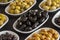 Assortment of olives on the plate in bulk. Close up