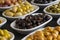 Assortment of olives on the plate in bulk. Selective focus