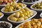 Assortment of olives on the plate in bulk. Selective focus