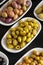 Assortment of olives on the plate in bulk. Story format