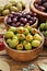 Assortment of olives in wooden bowl