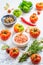 Assortment of organic tomatoes, spices and herbs on kitchen table