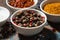 Assortment of pepper, different spices and sea salt in bowl