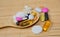 Assortment of pharmaceutical preparations, tablets and capsules on a spoon, on a bamboo mat