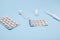 Assortment pharmaceutical therapeutic pills, drages and liquid dosage forms of medicaments on isolated blue background