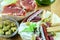 Assortment of products with vitamins and minerals for snack. Sandwiches with fresh jamon, fuet, chorizo sausages, bread sticks,