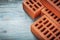 Assortment of red bricks on wooden board construction concept