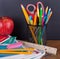 Assortment of School Suppies with Chalkboard Background