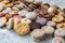 assortment of several delicious cookies artfully displayed on sleek marble table. Each cookie is masterpiece on its own