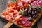 Assortment , sliced meat appetizer, prosciutto, salami and ham, with olives