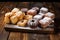 an assortment of sugar dusted pastries on a rustic wooden background