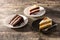 Assortment of sweet cake slices. Chocolate, carrot and velvet cake slices on wood