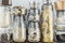 Assortment of uncooked grains, cereals and pasta in glass jars on wooden table. Healthy cooking, clean eating, zero