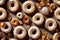 assortment of varied and appetizing doughnuts covered with glaze and colorful sprinkles. seamless dessert texture
