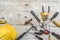 assortment of well-used hand tools spread out on a worn wooden surface, indicative of a workspace or a workbench