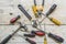 assortment of well-used hand tools spread out on a worn wooden surface, indicative of a workspace or a workbench