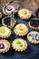 Assortments of mix sweet tartlets on dark stand, selective focus