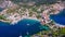 Assos, Greece. Aerial drone flight over picturesque village nestled on the idyllic Kefalonia, Greek Islands.