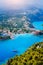 Assos village in morning light, Kefalonia. Greece. White lonely yacht in beautiful turquoise colored bay lagoon water