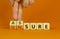 Assure or unsure symbol. Businessman turns wooden cubes and changes the concept word unsure to assure. Beautiful orange table,