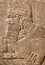 Assyrian wall relief of a genius from Mesopotamia, detail with a head