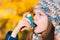 Asthma patient girl inhaling medication for treating shortness o