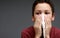 asthmatic breathing problems catching the flu child blowing nose after having a cold on grey background with people stock photo