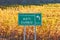 Asti Cuneo motorway street sign and vineyard in autumn in Italy