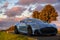 Aston Martin DBS superleggera on a scenic road at sunset