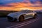 Aston Martin DBS superleggera on a scenic road at sunset