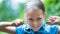 Astonished happy girl in blue shirt having fun in the park