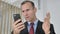Astonished Middle Aged Businessman Shocked by Result on Smartphone, Wondering