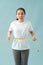 Astonished slim woman measuring her waist