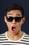 Astonished young Asian man in sunglasses