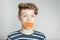 Astonished young boy with a mouthful of carrot