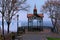 Astonishing landscape of panoramic viewing platform with beautiful arbor in foggy autumn morning in the Saint Volodymyr Hill.