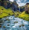 Astonishing midnight sun view of Kvernufoss watterfall. Captivating summer scene of pure water river in Iceland, Europe. Beauty of