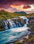 Astonishing summer sunset on Bruarfoss Waterfall, secluded spot with cascading blue waters.