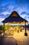 Astonishing view of lighted palm pergola on hotel rooftop under dark blue sky