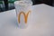Astrakhan, Russia 13 Feb. 2019: McDonalds takeaway cola paper cup on table in shopping mall food court. McDonalds fast