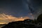 Astro night sky, Milky way galaxy stars over the Alps, stormy sky, Mars planet beyond the clouds, snowcapped mountain range