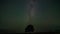 Astro timelapse of an pine tree silhouetted against the night sky with the Milky Way rising in the North hemisphere