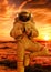 Astronaut doing namaste pose with a sunset beach as background