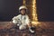 Astronaut futuristic kid girl with white full length uniform and helmet wearing silver shoes