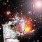 Astronaut gives thumbs-up against outer space, galaxies and stars. The elements of this image furnished by NASA
