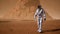 Astronaut goes on the surface of Mars through a dust storm past the giant solar panels. Panoramic landscape on the