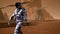 Astronaut goes on the surface of Mars through a dust storm past the giant solar panels. Panoramic landscape on the