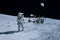 Astronaut near the moon rover on the moon. With land on the horizon. Elements of this image were furnished by NASA
