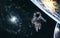 Astronaut, planets on background of spiral galaxy somewhere in deep space