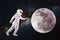 Astronaut in space and moon exploration. Concept, astronaut pulls his hand to the lunar surface
